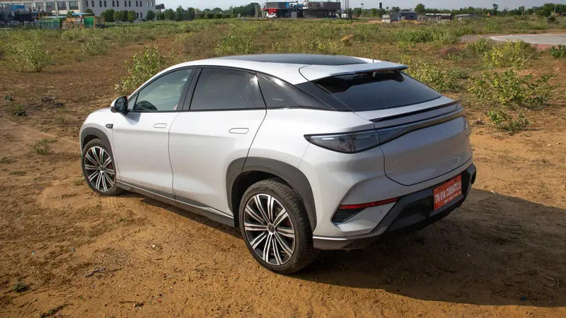 Rear three-quarter view showing LED tail lights and rear spoiler