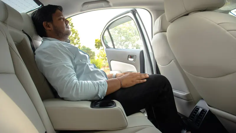 Rear seating with beige upholstery, centre armrest and rear AC vents
