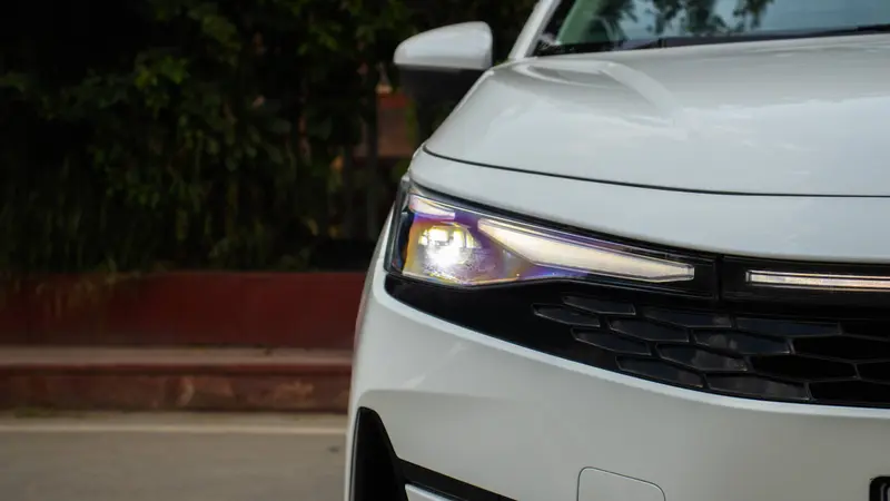 Close-up of the signature Bi-LED projector headlamp with integrated split LED DRL and turn signal