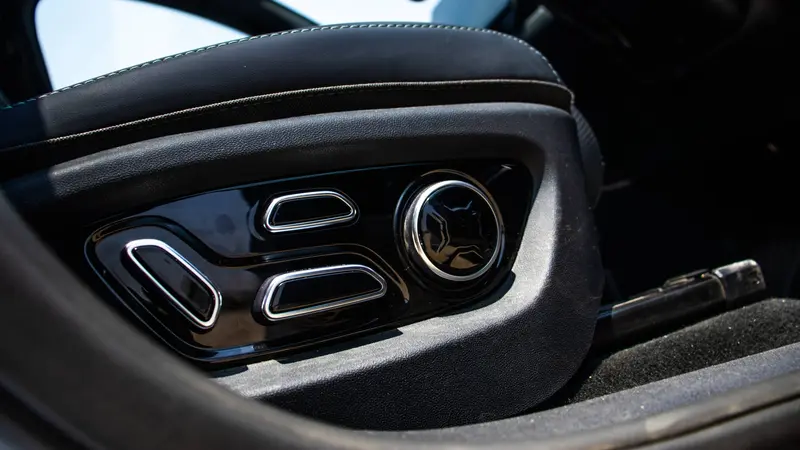 Driver seat power adjustment controls