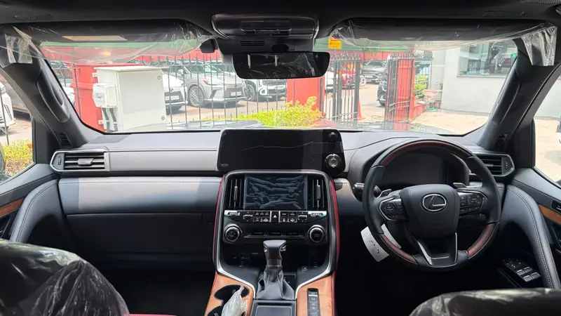 dashboard with touchscreen displays and leather-and-wood steering wheel
