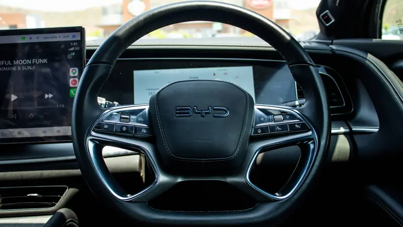 Genuine leather-wrapped steering wheel with mounted audio, phone, ACC and multi-function display controls