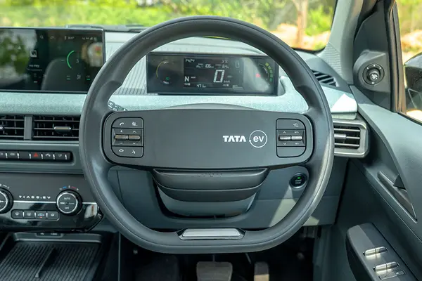 The steering wheel gets mounted controls and an off-centre Tata.ev logo.
