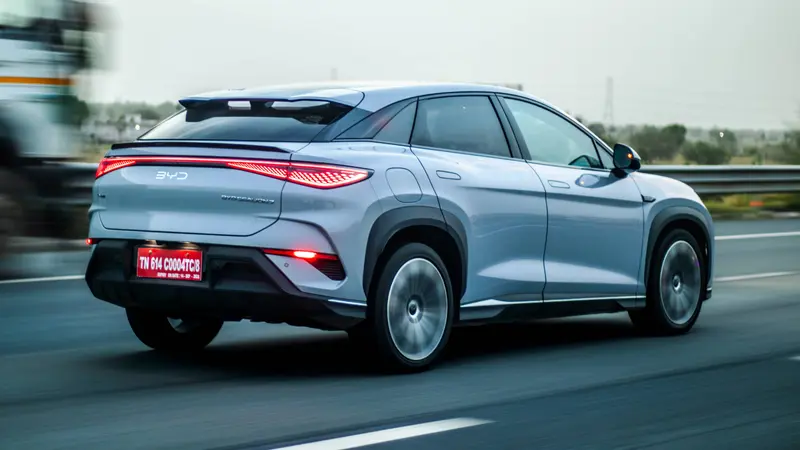 Rear three-quarter view showing the coupe-SUV body design and full-width LED tail lights