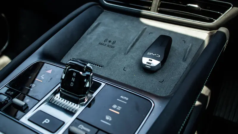Wireless phone charger and electronic gear selector on the centre console