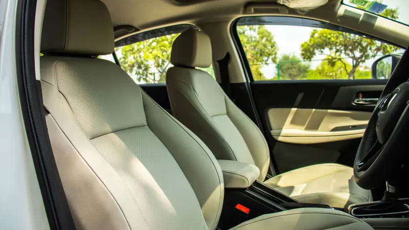 Front cabin showing beige leather seats and centre console