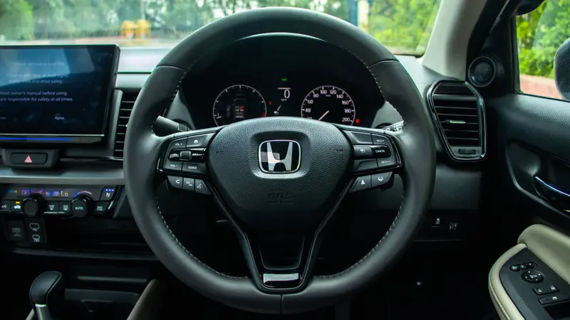 Steering wheel with mounted audio, phone, voice recognition and cruise control buttons