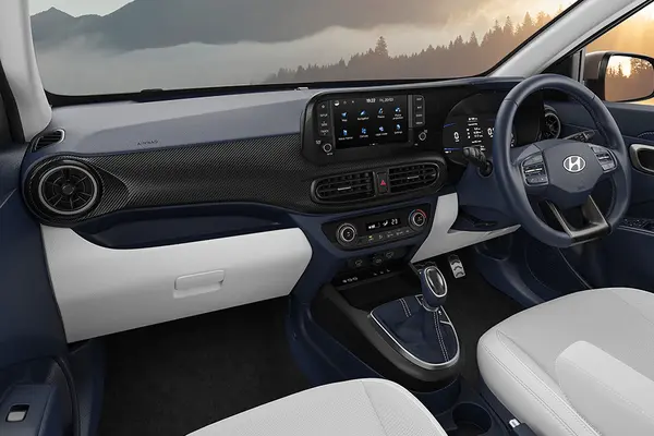 Its dashboard gets a dual-tone Navy Blue and Grey cabin theme with a 3D carbon-pattern.