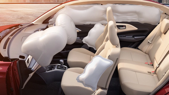 Maruti Suzuki Dzire's interior demonstrating deployed safety airbags, including front, side, and full-length curtain airbags protecting the passenger cabin