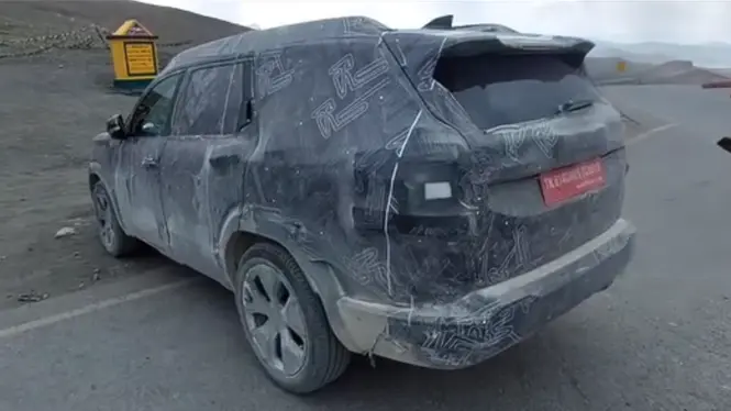 Camouflaged Renault test SUV viewed from the rear three-quarter angle during testing in Ladakh.